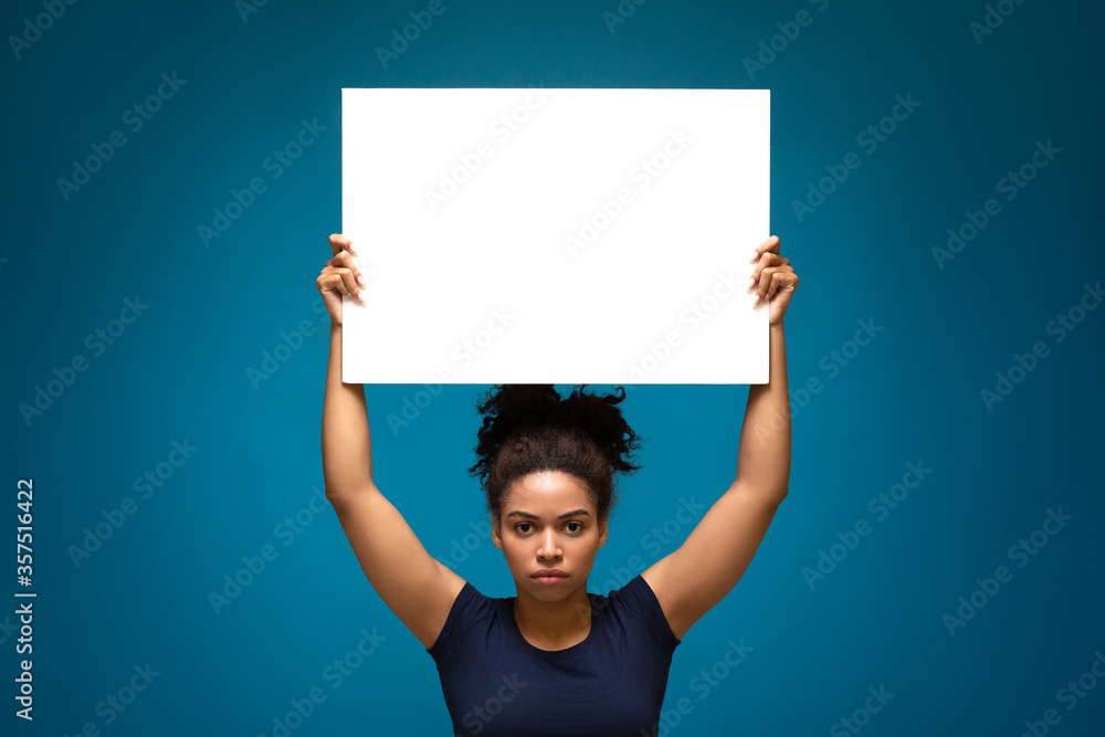 African american woman protesting with blank placard, African american woman protesting with blank placard,