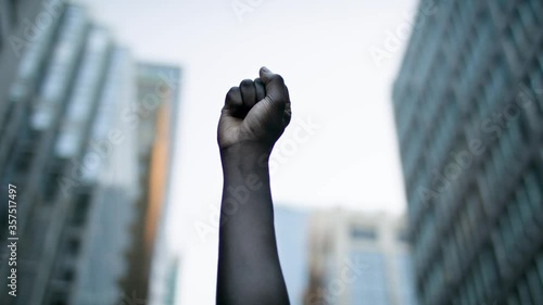 Raised black man's fist in protest. Social justice and peaceful protesting racial injustice. Shot in 4k.