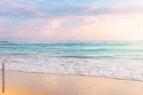 Soft ocean wave and beautiful cloudy sky. Fantastic sunset shore background.