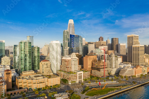 Aerial daytime view of the San Francisco skyline, near the Embarcadero area. Ferry building is visible in foreground, plenty of copy space in blue sky © Patrick