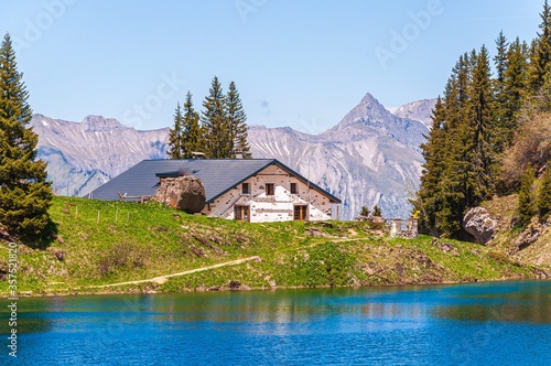 House in front of the Lac Lioson lake in Switzerland photo