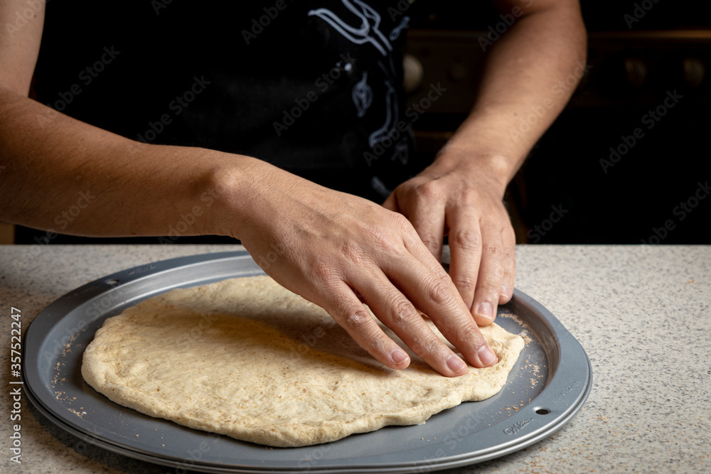 Fototapeta premium Male hands preparing homemade pizza