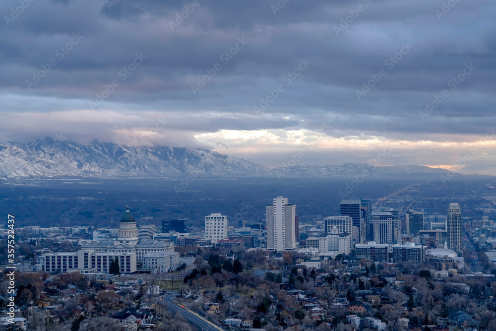 Downtown Salt Lake City with amazing view of steep snowy mountain in winter