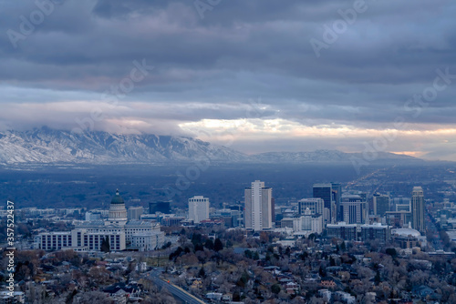 Downtown Salt Lake City with amazing view of steep snowy mountain in winter