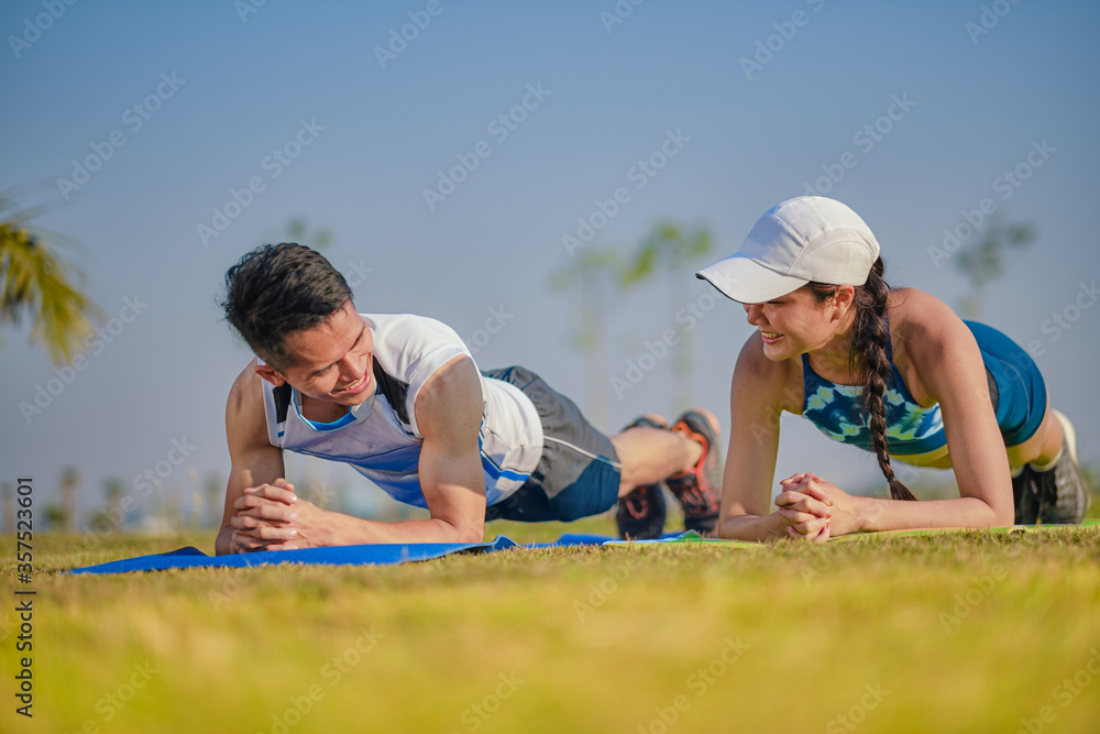 Sport fitness couple planking together. Healthy lifestyle concept