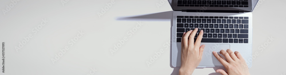 Person using a laptop computer from above - obrazy, fototapety, plakaty 