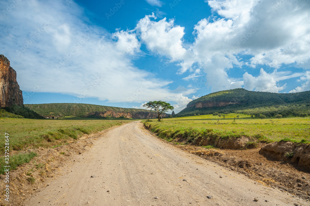 African dirty road and blue sky with clouds
