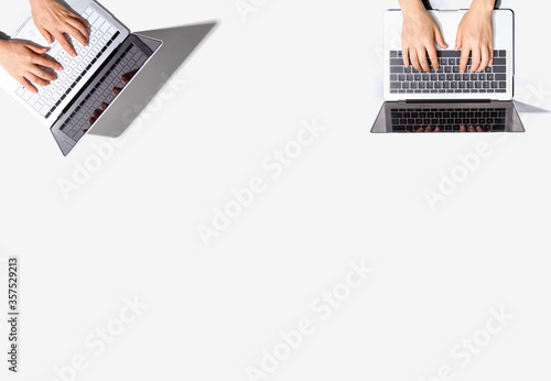 Two people working together with laptop computers