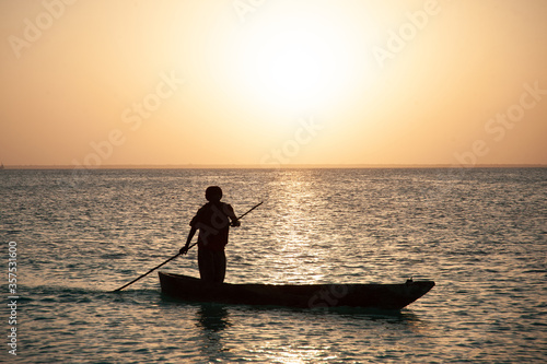 Sunset and fisherman boat in the ocean