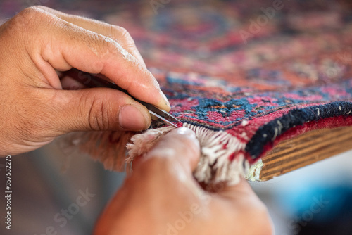 traditional hand sewing fixing old vintage antique persian carpet up close