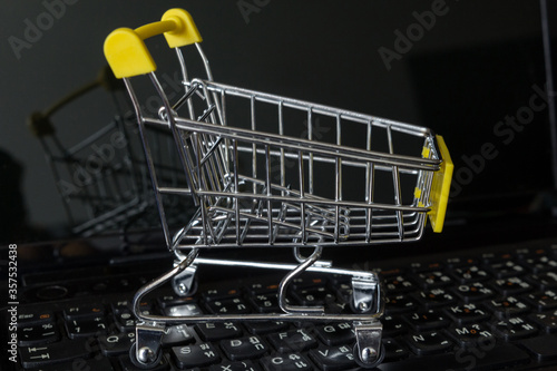 Shopping cart or trolley on laptop keyboard.Shopping online concept
