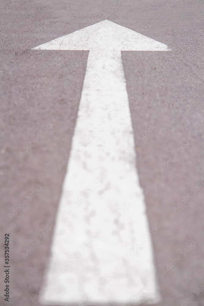 Close up white forward arrow on running track. Asphalt walk way in park. Stock photography. Close up white forward arrow on running track. Asphalt walk way in park. Stock photography.
