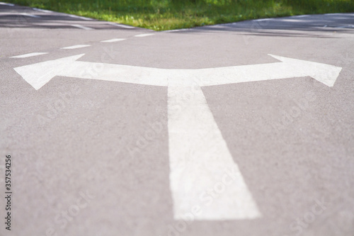 Closeup running track with fork sign on asphalt in park. Concept Business Decision way. Stock photography.