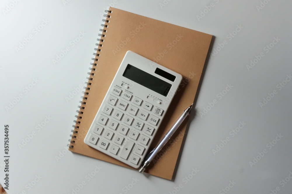 studying or household accounting or working - a calculator, a pen and a notebook studying or household accounting or working - a calculator, a pen and a notebook