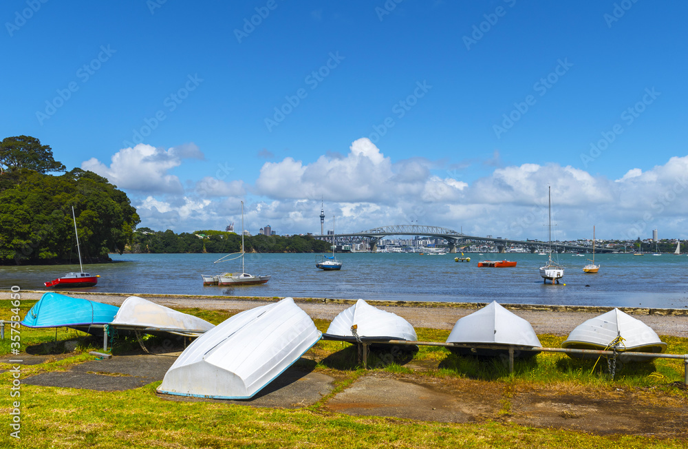 Dinghy at Little Shoal Reserve Bay Beach Auckland, New Zealand; Harbour Bridge and Auckland City Landscape as the Background