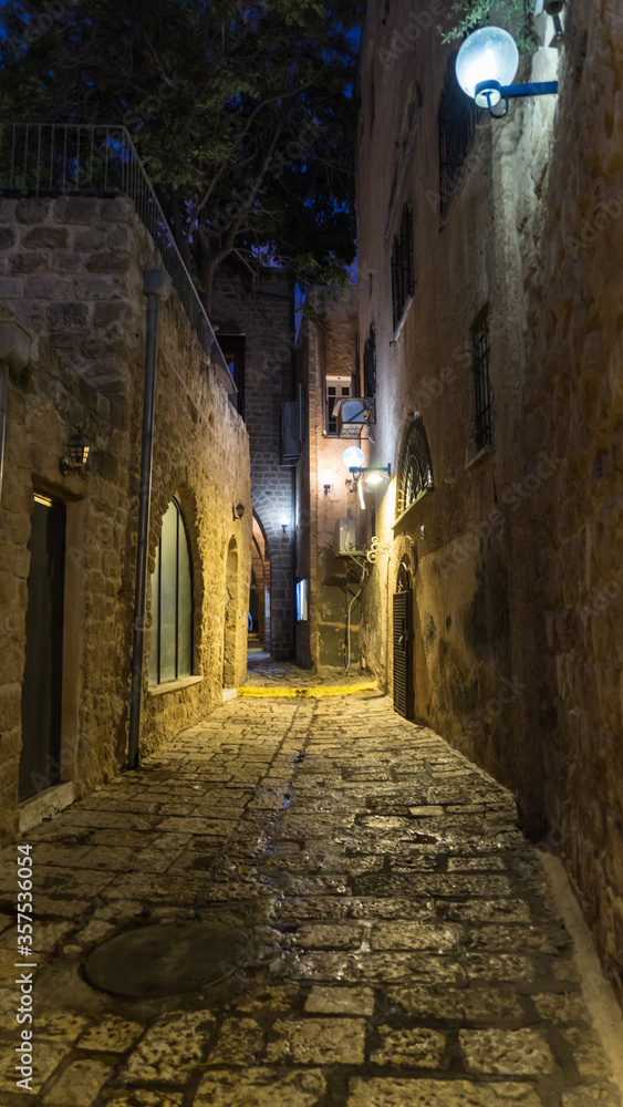 White stone house on narrow street of Old Yafo (Jaffa) at night. Tel Aviv, Israel.