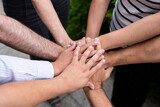 circle of people with hands together on top view showing teamwork unity and friendship