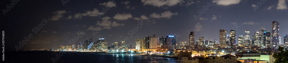 Panoramic view at night. Seascape and skyscrapers on background in Tel Aviv, Israel. Panoramic view at night. Seascape and skyscrapers on background in Tel Aviv, Israel.