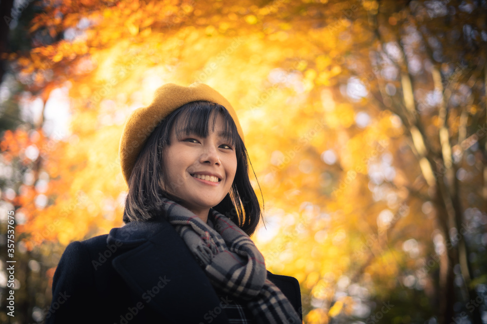 Lifestyle portrait of pretty smiley young Asian woman traveller in autumn season park, Tokyo, Japan Lifestyle portrait of pretty smiley young Asian woman traveller in autumn season park, Tokyo, Japan