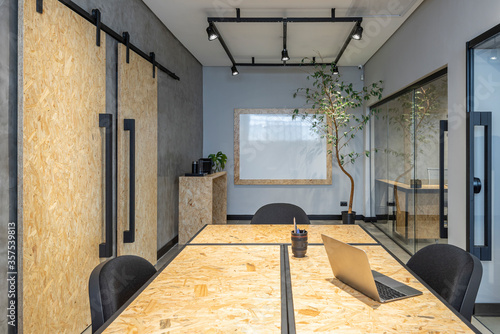 interior design of a office with notebook osb table and sliding doors