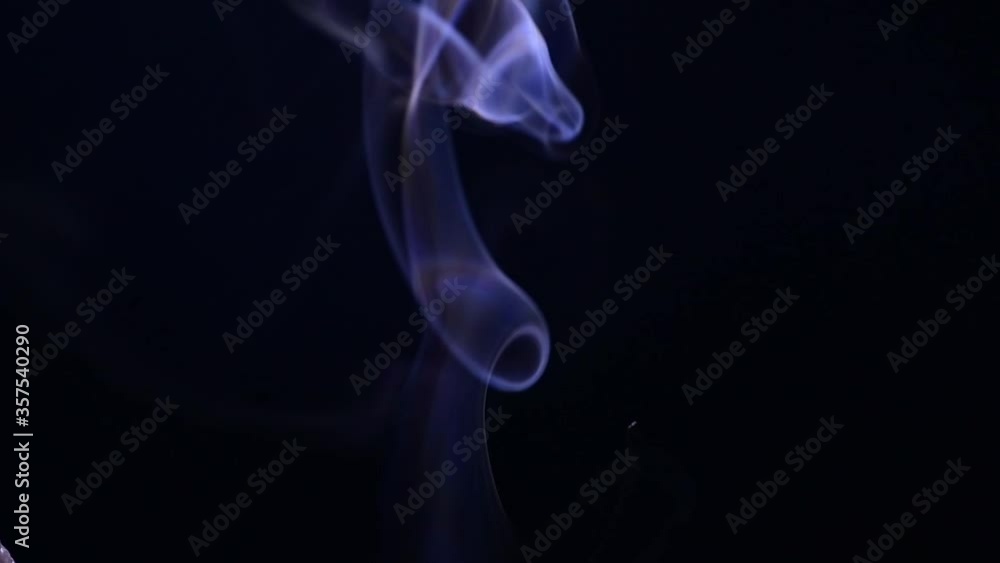 Purple smoke rises in the black background. Slowly disappearing smoke Purple smoke rises in the black background. Slowly disappearing smoke