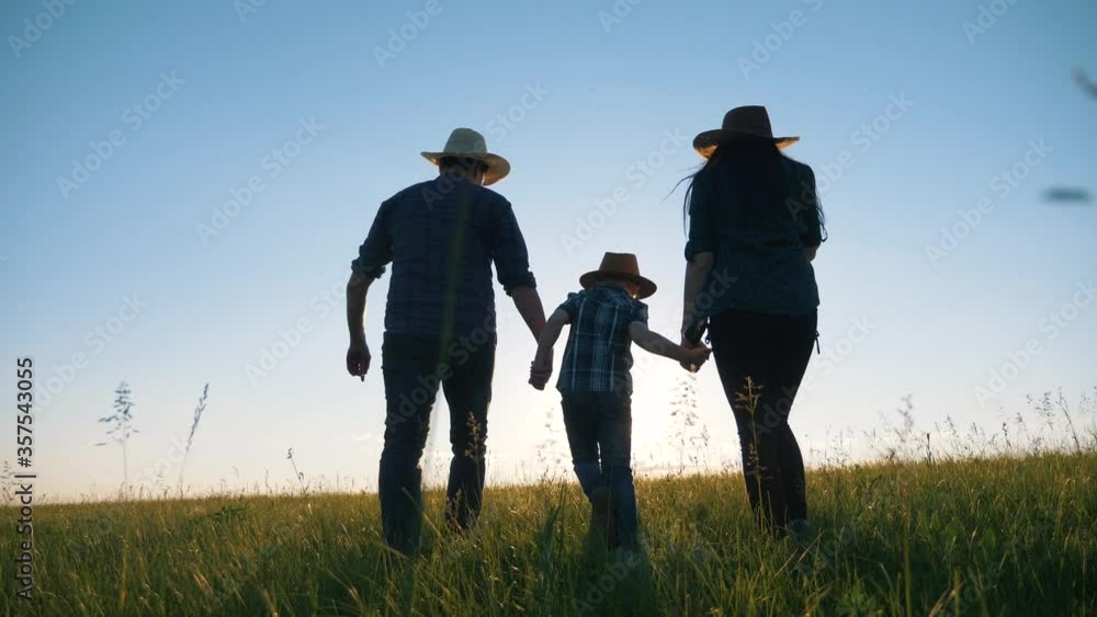 Healthy happy family. Parents father mother son walk in a wheat field in the evening sunset. The concept of fatherhood, motherhood, friendship, teamwork. Healthy happy family. Parents father mother son walk in a wheat field in the evening sunset. The concept of fatherhood, motherhood, friendship, teamwork.