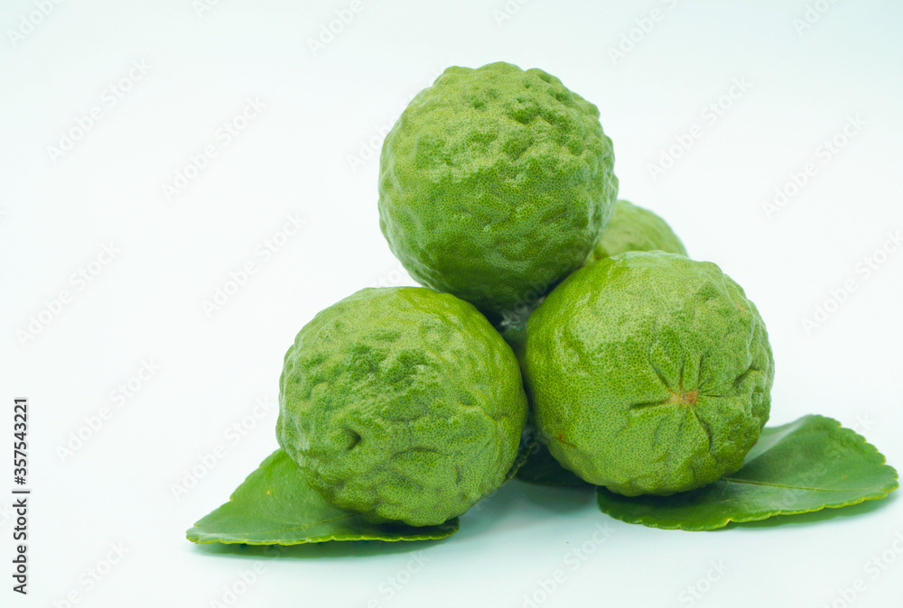 Fototapeta premium Fresh bergamot fruit with leaf and cut in half of bergamot on white background