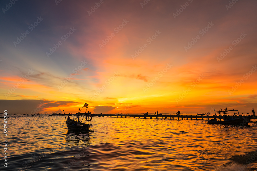 Silhouette Small fishing boat at shore in sunset at Bang Phra Beach,sriracha choburi,thailand