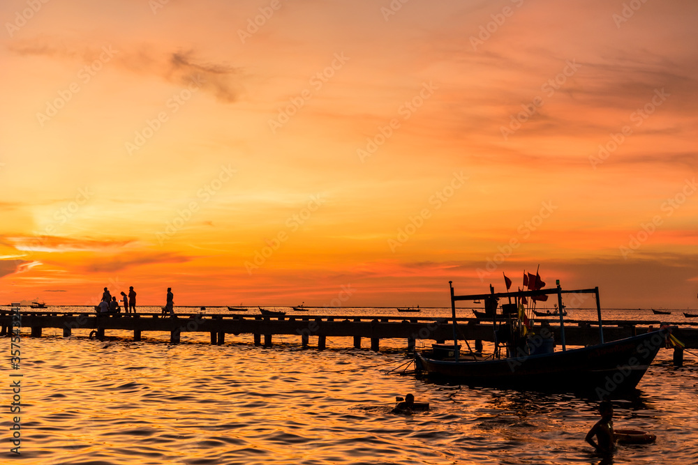 Silhouette of Harbor bridge and people during sunset at Bang Phra Beach,sriracha choburi,thailand