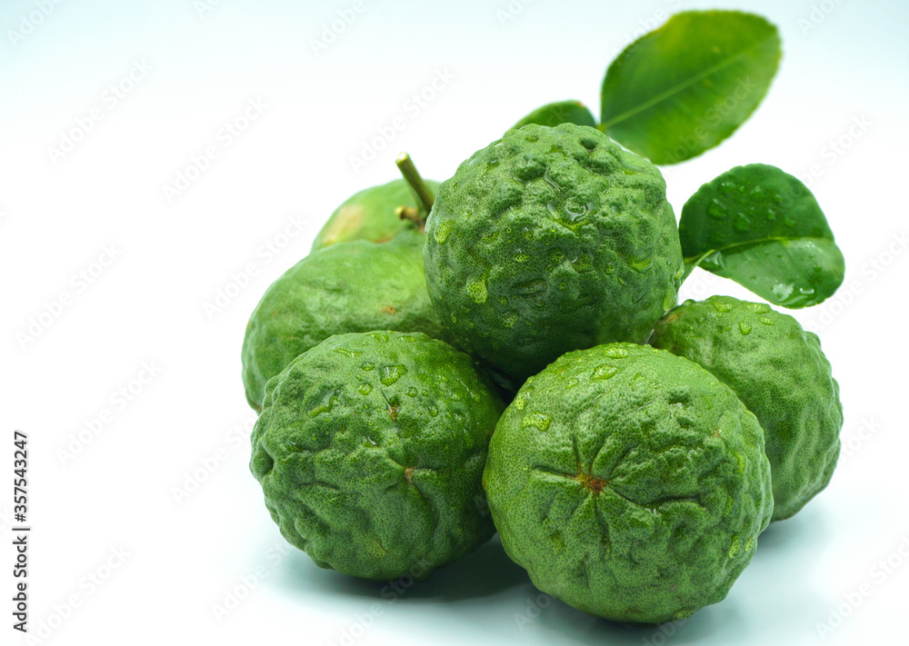 Fresh bergamot fruit with leaf and cut in half of bergamot on white background Fresh bergamot fruit with leaf and cut in half of bergamot on white background