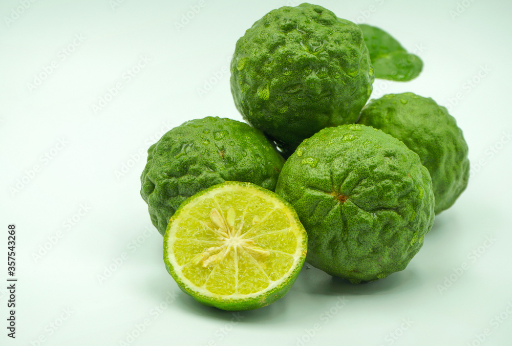 Fresh bergamot fruit with leaf and cut in half of bergamot on white background Fresh bergamot fruit with leaf and cut in half of bergamot on white background