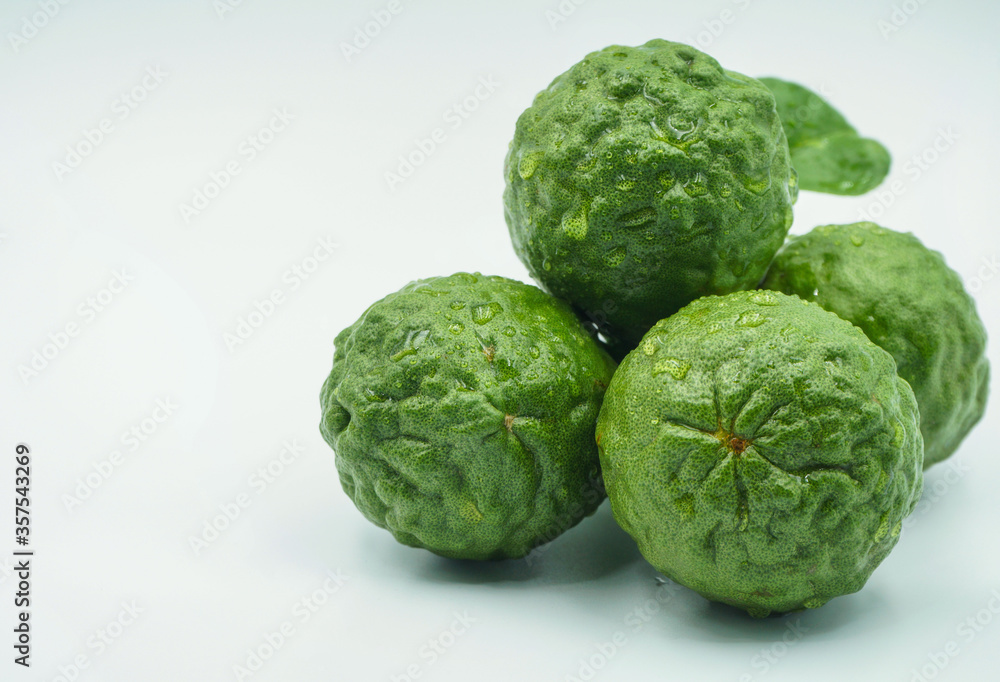 Fresh bergamot fruit with leaf and cut in half of bergamot on white background Fresh bergamot fruit with leaf and cut in half of bergamot on white background
