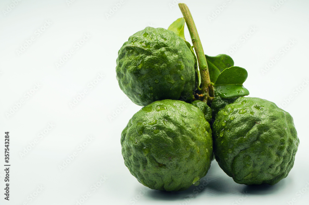 Fresh bergamot fruit with leaf and cut in half of bergamot on white background Fresh bergamot fruit with leaf and cut in half of bergamot on white background