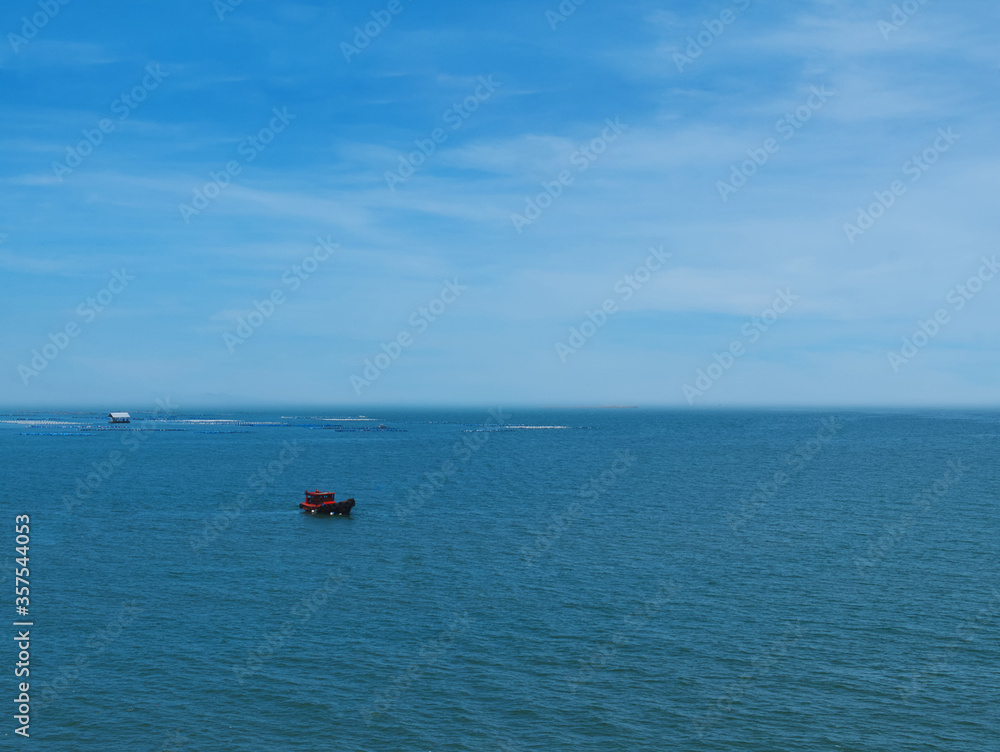 Tranquil Scenery of a Red Boat on the Blue Sea Tranquil Scenery of a Red Boat on the Blue Sea