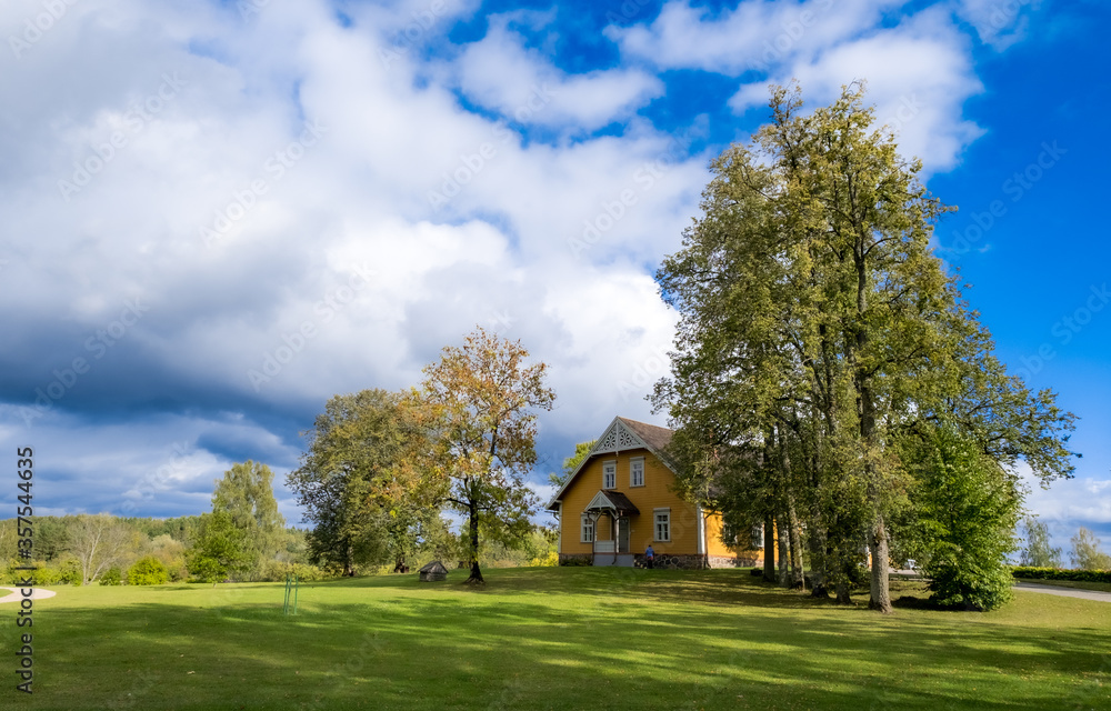 A meadow with old wooden house in Turaida Castle park, Latvia A meadow with old wooden house in Turaida Castle park, Latvia