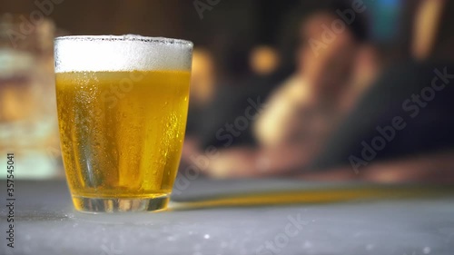 a glass of beer on bar background
