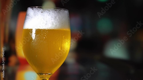 a glass of beer on bar background