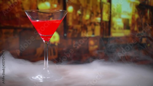cocktail in a martini glass on bar background.