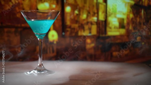 cocktail in a martini glass on bar background.