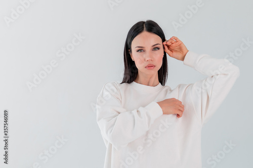 Portrait beautiful adult sports girl model on white background. hoody. logo. photo