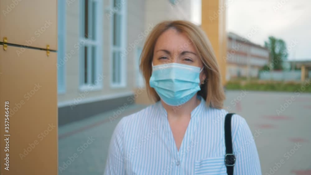 Antivirus protection. A woman in a protective surgical face mask walks down the street alone. Quarantine, pandemic, no-man's land. Antivirus protection. A woman in a protective surgical face mask walks down the street alone. Quarantine, pandemic, no-man's land.