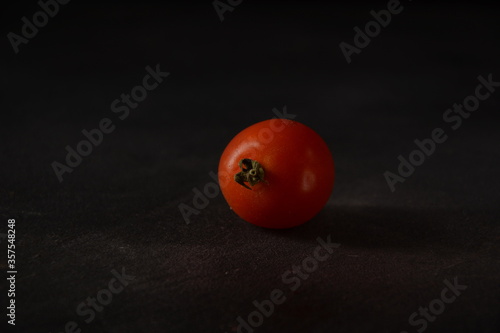 Fresh tomato on dark background