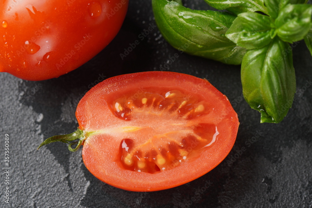 Piece of cut fresh tomato over dark background.
Tomato with droplets of water. Close up Piece of cut fresh tomato over dark background.
Tomato with droplets of water. Close up