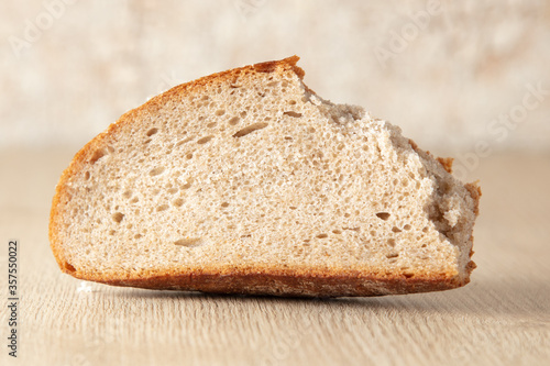 Fresh sliced bread on a wooden background.