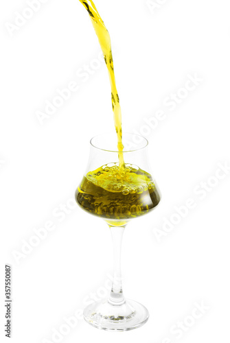 pouring cocktail in glass on white background