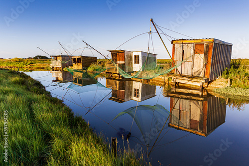 Reflection of Fisheries of brittany marsh in Vendee photo