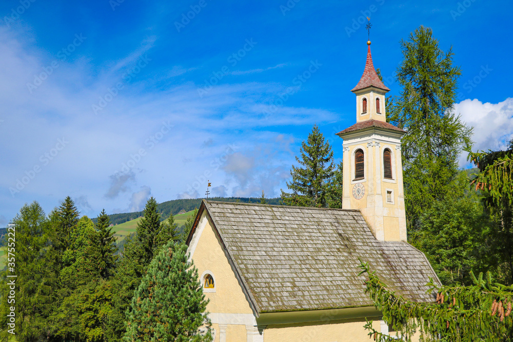 Old church surrounded by fir trees on a background of mountains. Old church surrounded by fir trees on a background of mountains.