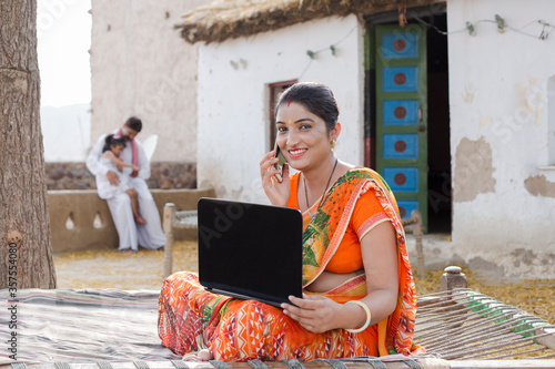 Photography Young rural woman doing online shopping at home