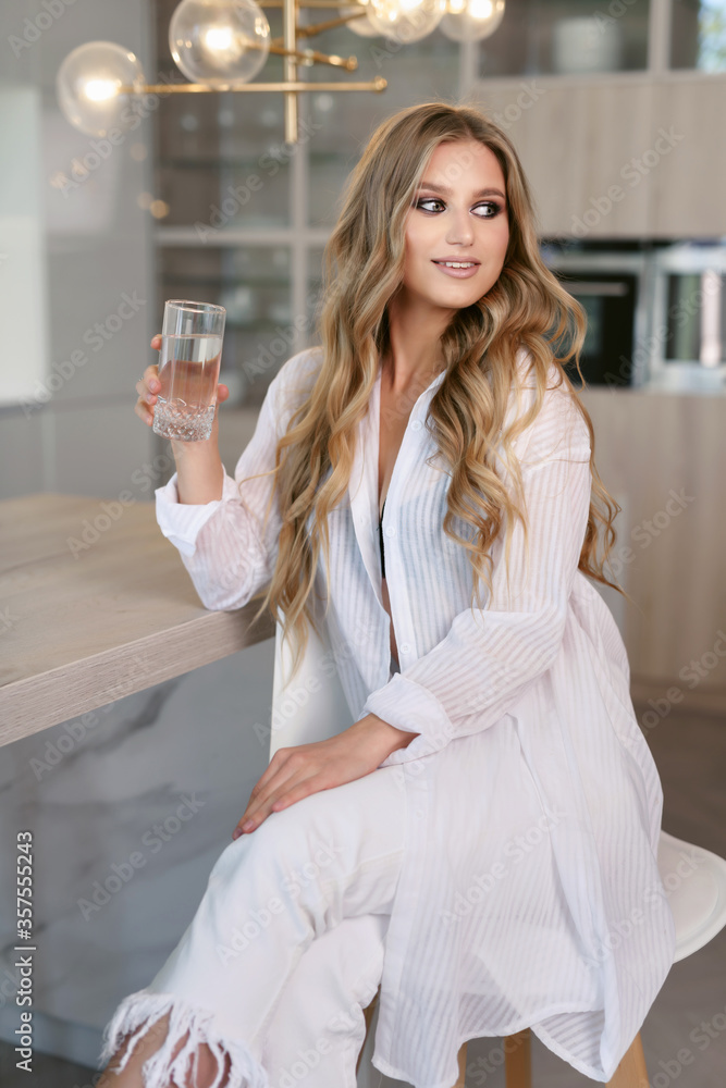 Portrait of a nutritionist. Young happy cheerful attractive woman holds a glass of clean drinking water. Healthy lifestyle concept. Portrait of a nutritionist. Young happy cheerful attractive woman holds a glass of clean drinking water. Healthy lifestyle concept.