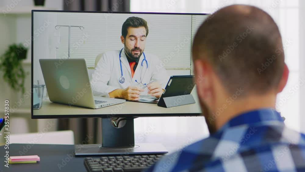 Patient on video call with doctor talking about his rehabilitation. Handicapped invalid paralysed freelancer, immobilized entrepreneur working from home, ilness and disability Patient on video call with doctor talking about his rehabilitation. Handicapped invalid paralysed freelancer, immobilized entrepreneur working from home, ilness and disability